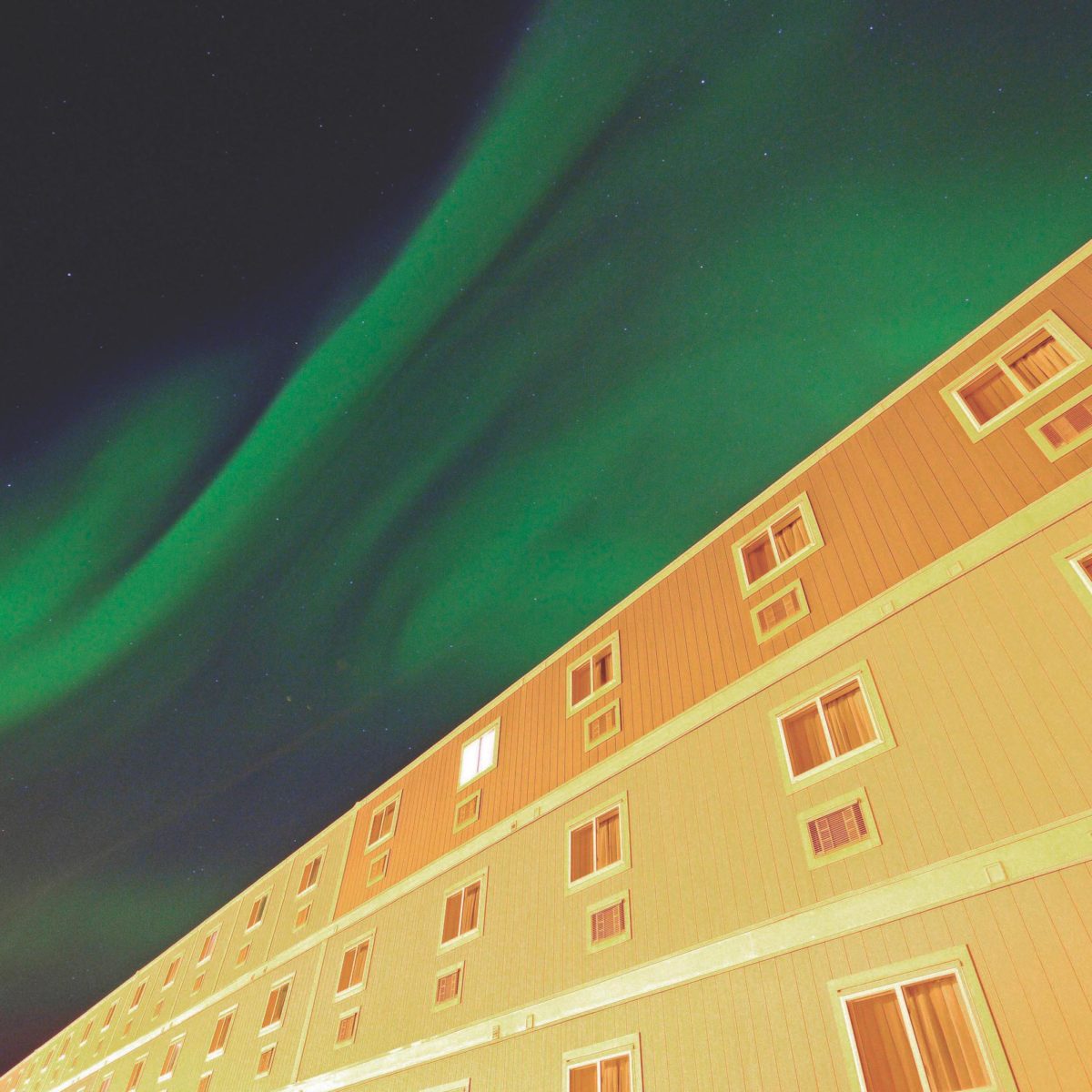Northern Lights above a workforce accommodations village in the arctic